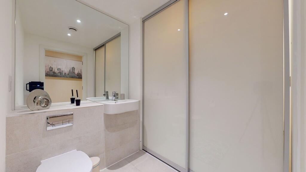 A modern bathroom suite featuring a sleek wall-...