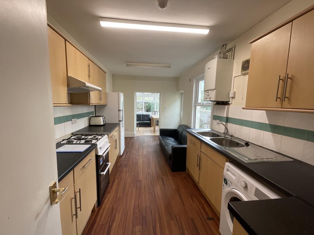 A bright and tidy kitchen featuring wood-effect...