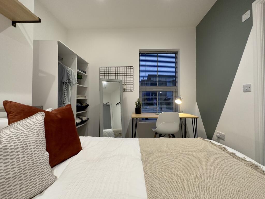A bright and inviting double bedroom with moder...