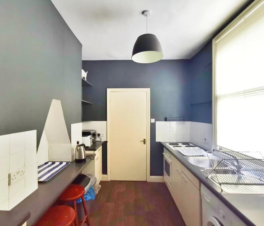 A compact and tidy kitchen featuring modern app...