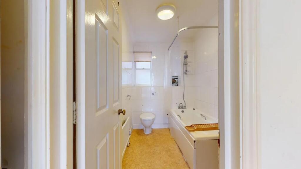 A bright and clean bathroom featuring a full-si...