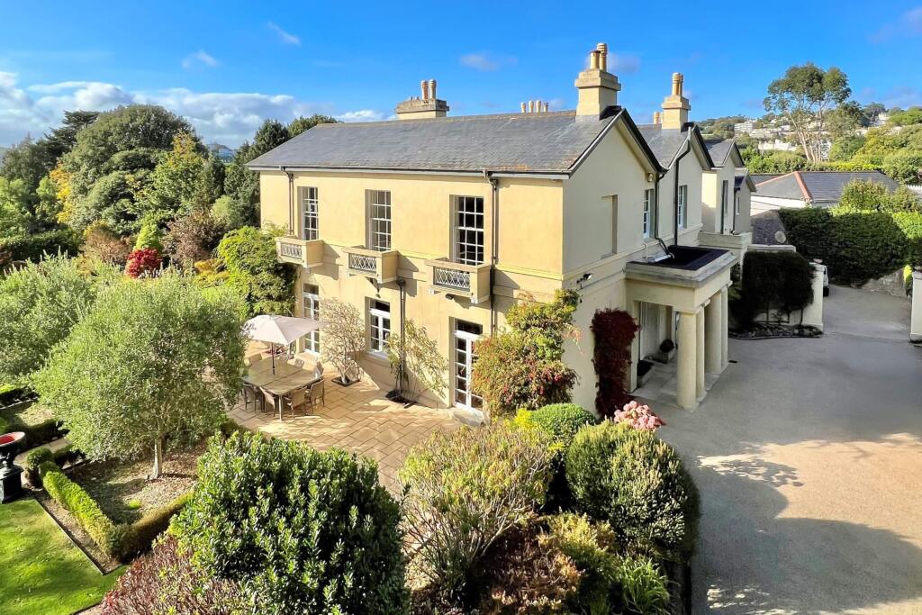 Driveway view with terrace and pillared entrance