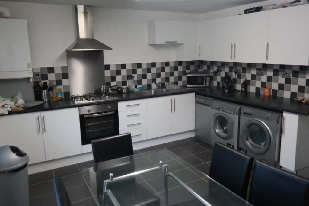 A spacious and modern kitchen with ample storag...