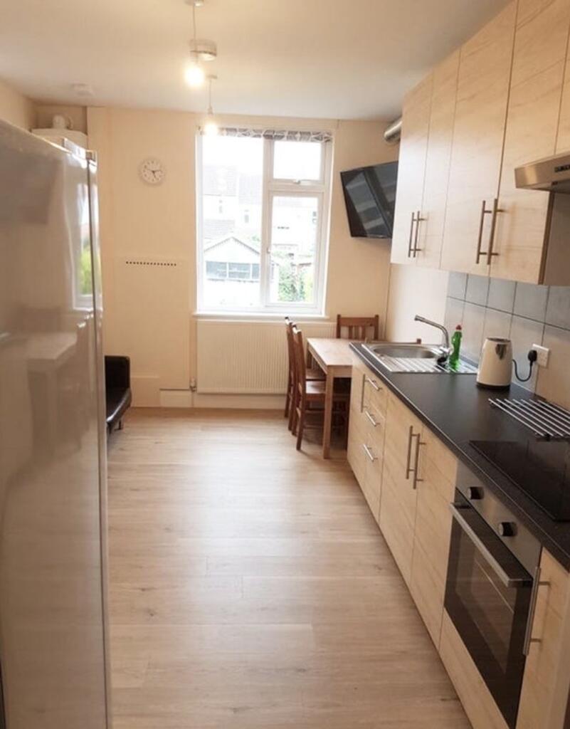 Bright and modern kitchen featuring sleek cabin...