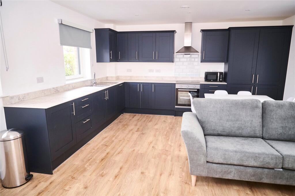Bright and modern kitchen featuring sleek black...