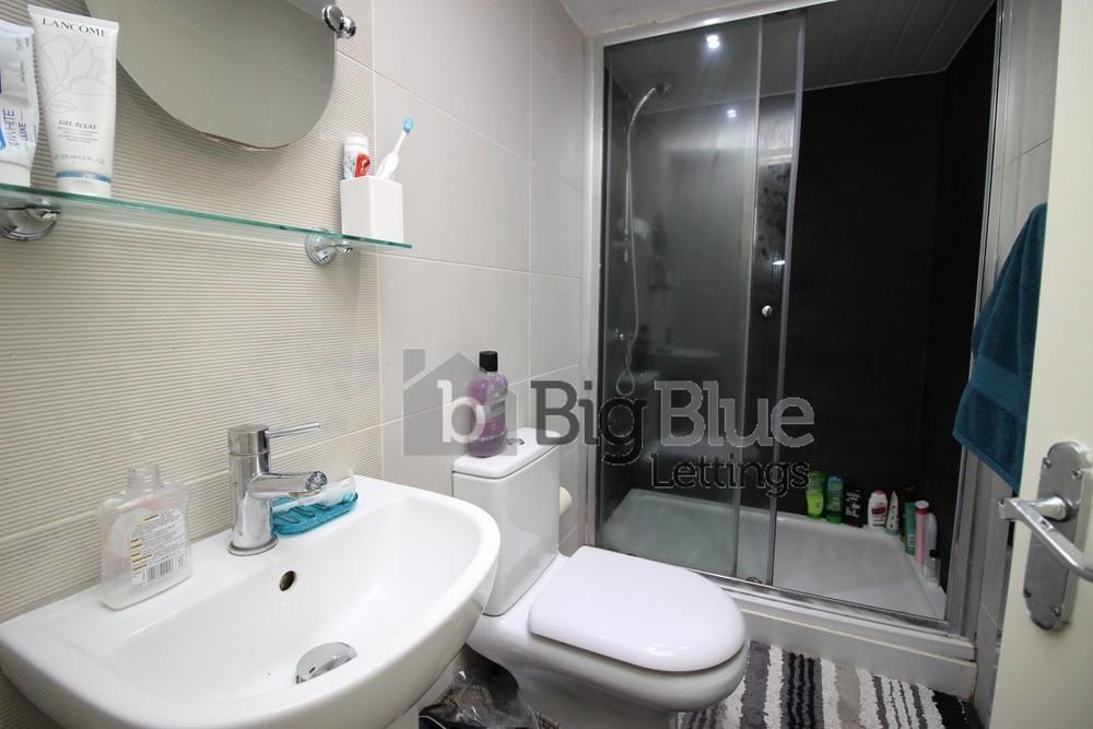 A modern bathroom featuring a clean white sink,...