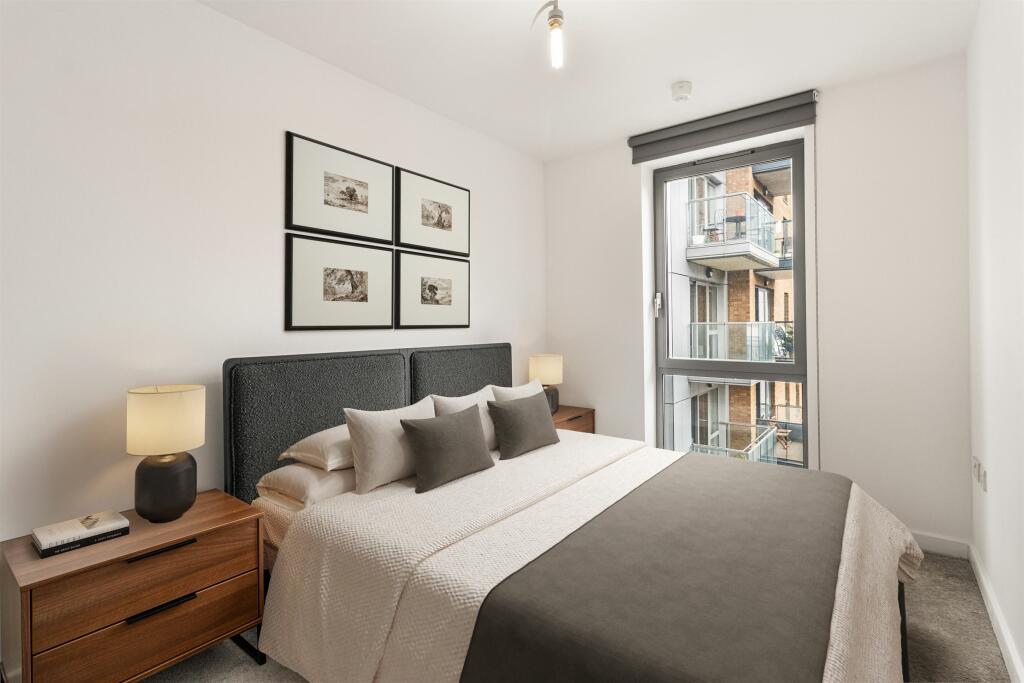 Relax in style in this contemporary bedroom oasis, featuring sleek design and ample natural light.