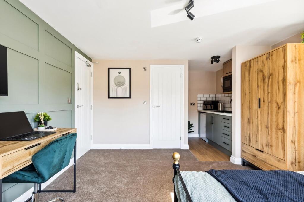 This charming double bedroom features a cozy la...