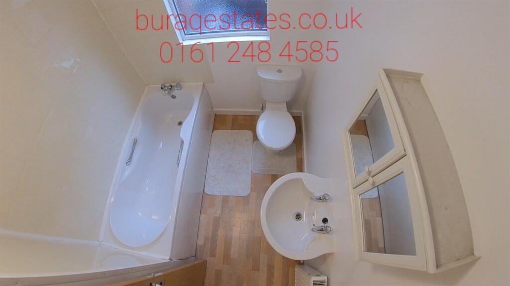 Bright and clean bathroom suite featuring a ful...