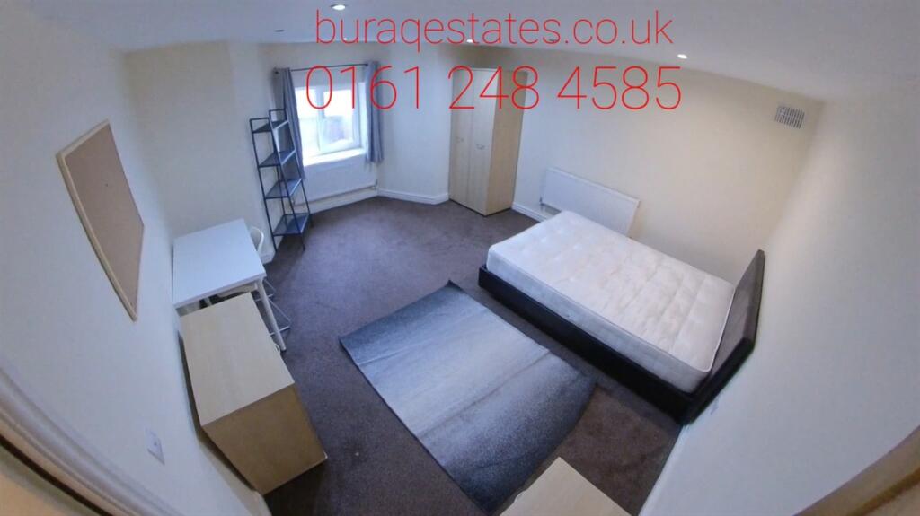 A well-maintained double bedroom featuring a la...