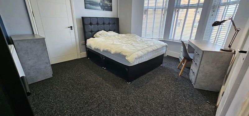 A cozy single bedroom featuring a comfortable d...