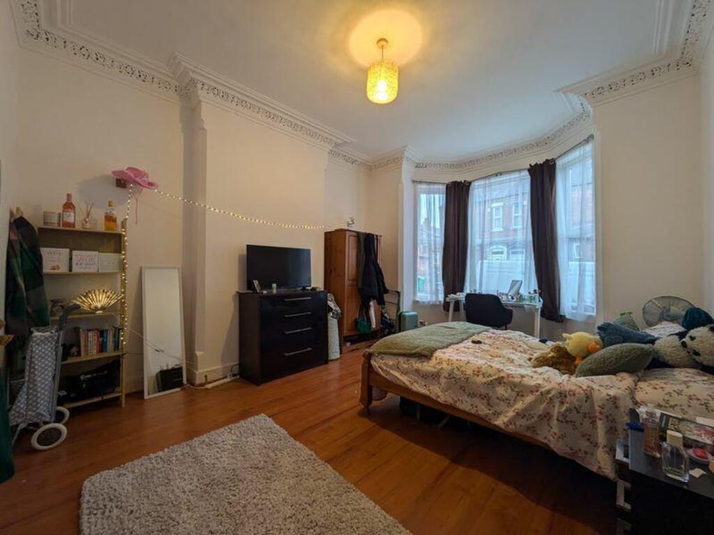 A spacious and inviting double bedroom filled w...