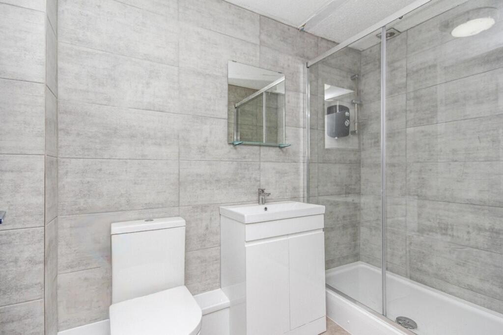 A modern and pristine bathroom featuring a styl...
