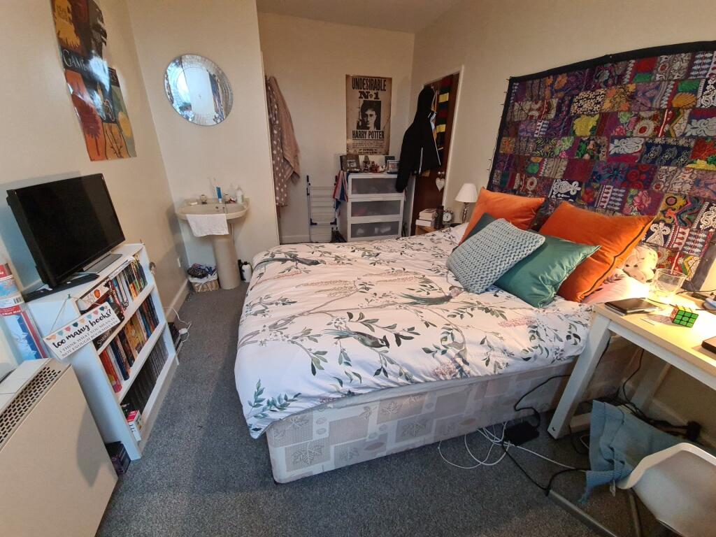 Cozy double bedroom with a comfortable bed, bed...