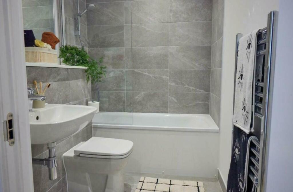 A modern and tidy bathroom featuring a stylish ...