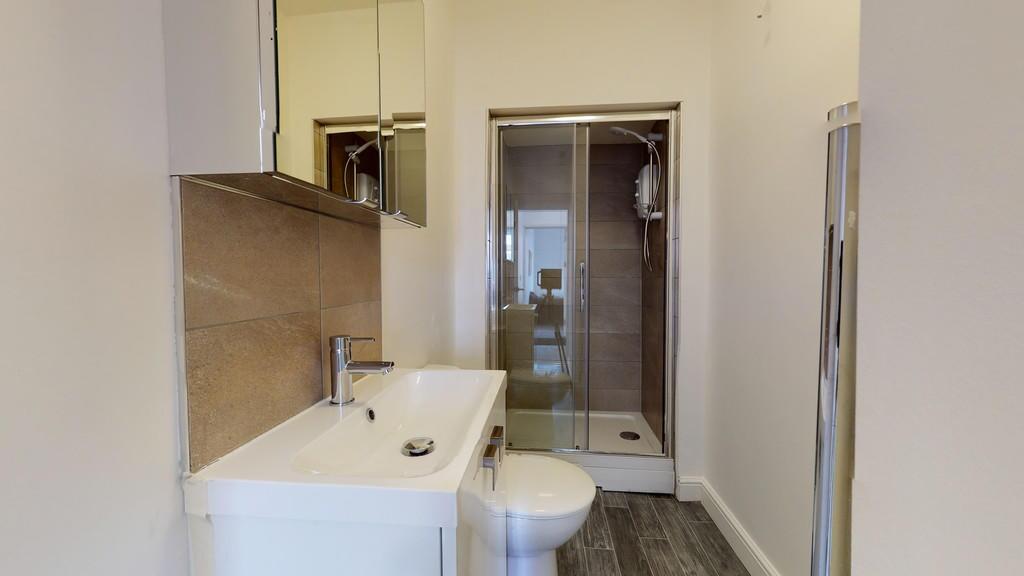 A modern bathroom featuring a clean white sink ...