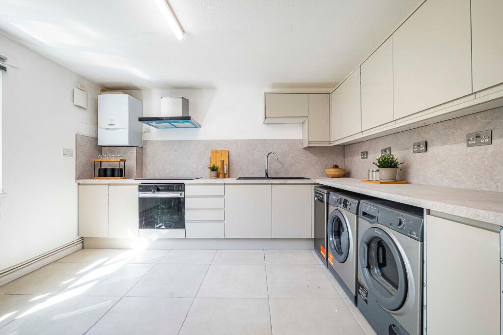 Bright and modern kitchen with ample counter sp...