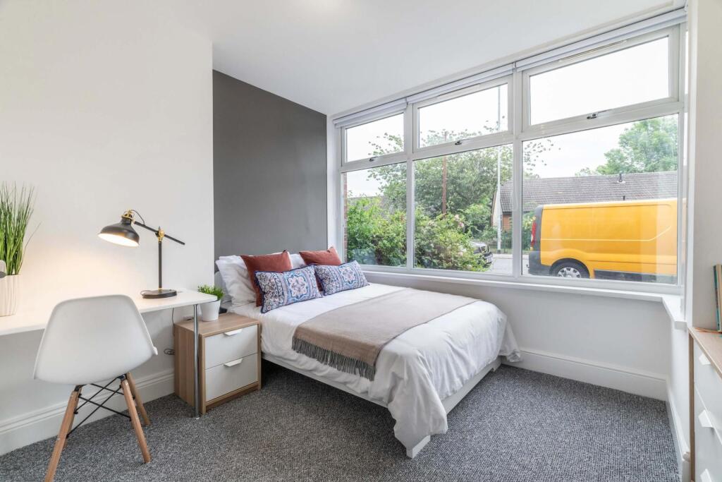 A bright, spacious master bedroom featuring a l...