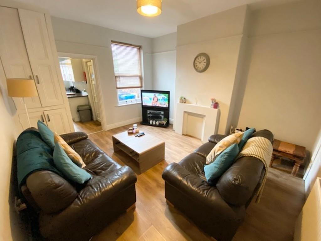 A cozy and well-maintained living room featurin...