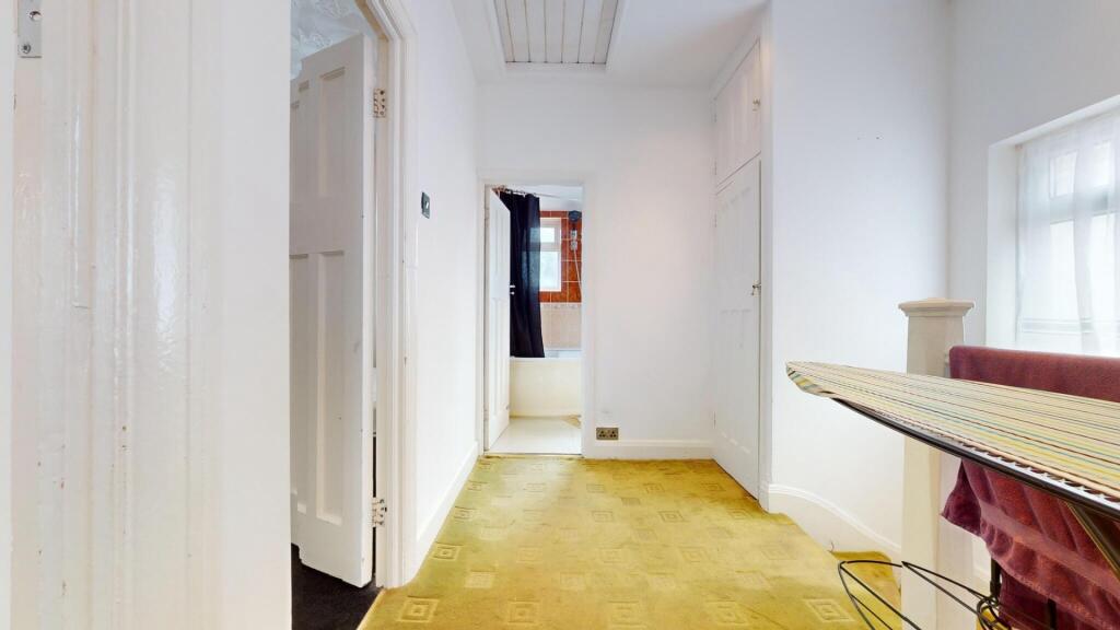 A bright and tidy hallway with clean white wall...