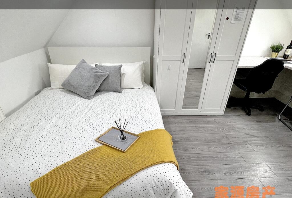 A bright and neatly arranged double bedroom fea...