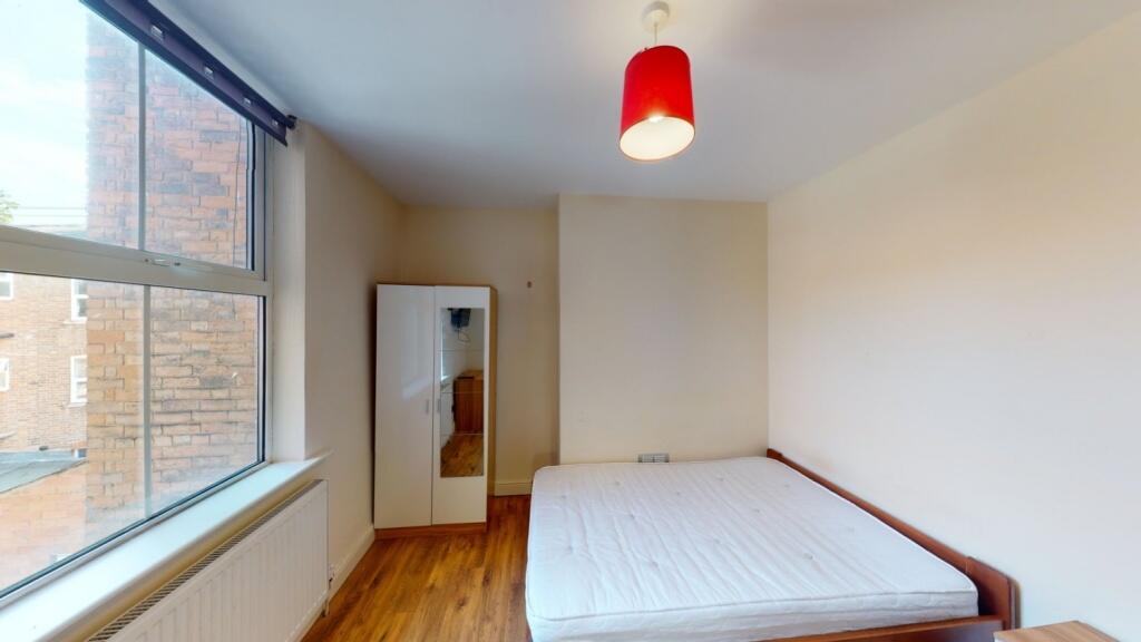 Bright and simple double bedroom featuring a la...