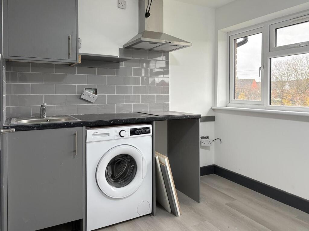Compact modern kitchen with grey cabinetry, int...