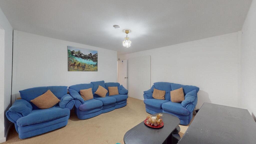 A bright and welcoming living room featuring tw...
