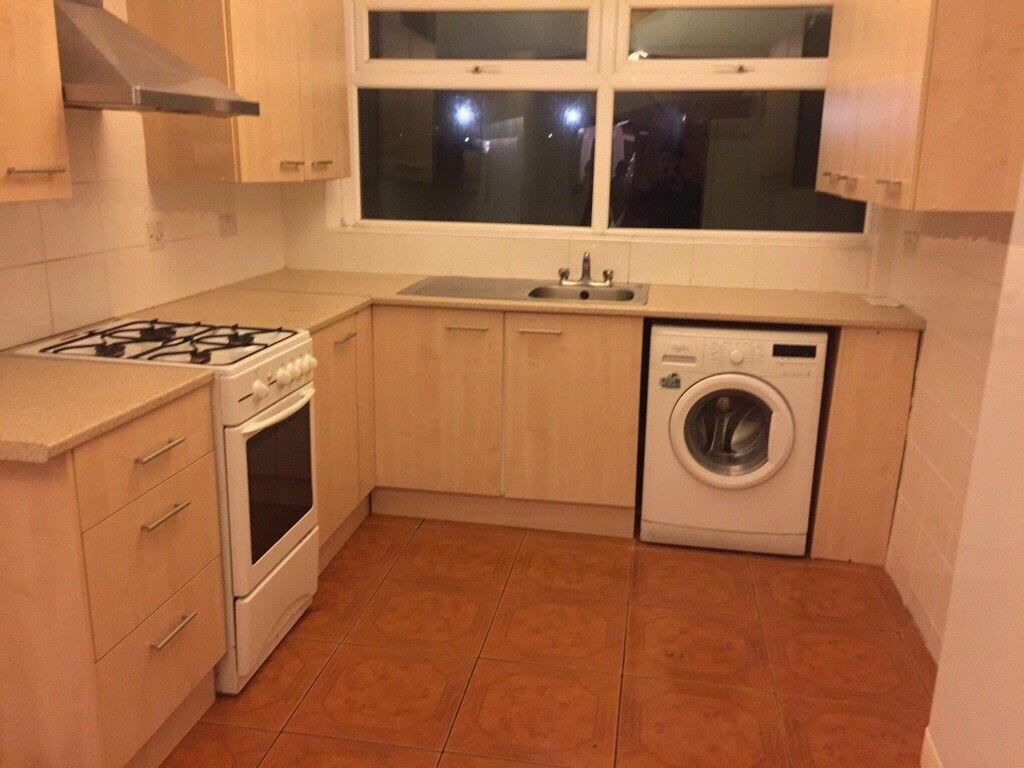 Fitted kitchen with light wood cabinets, freest...