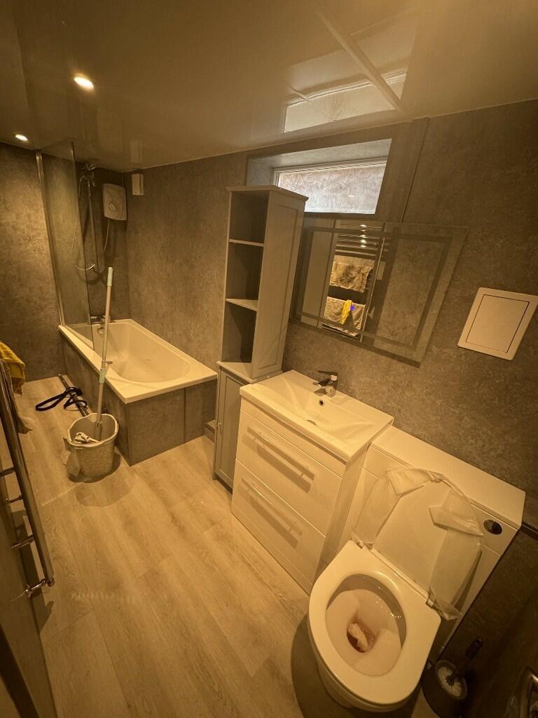 A modern bathroom suite featuring a full bathtu...
