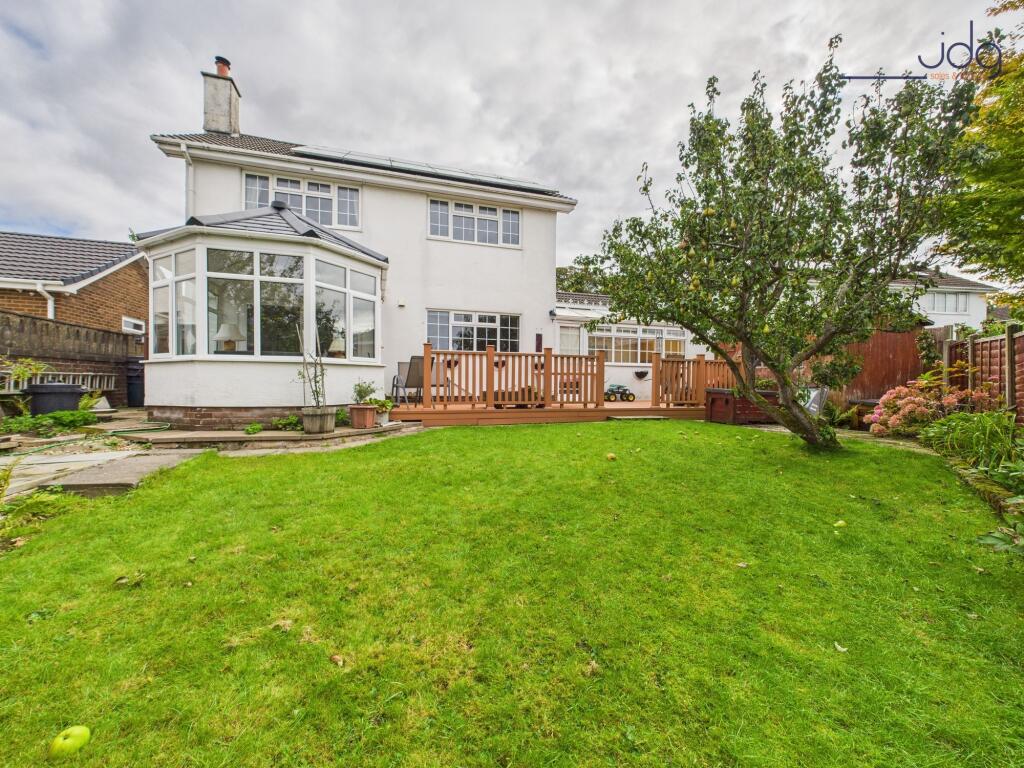 Spacious garden to the rear of the property with decking and fruit trees
