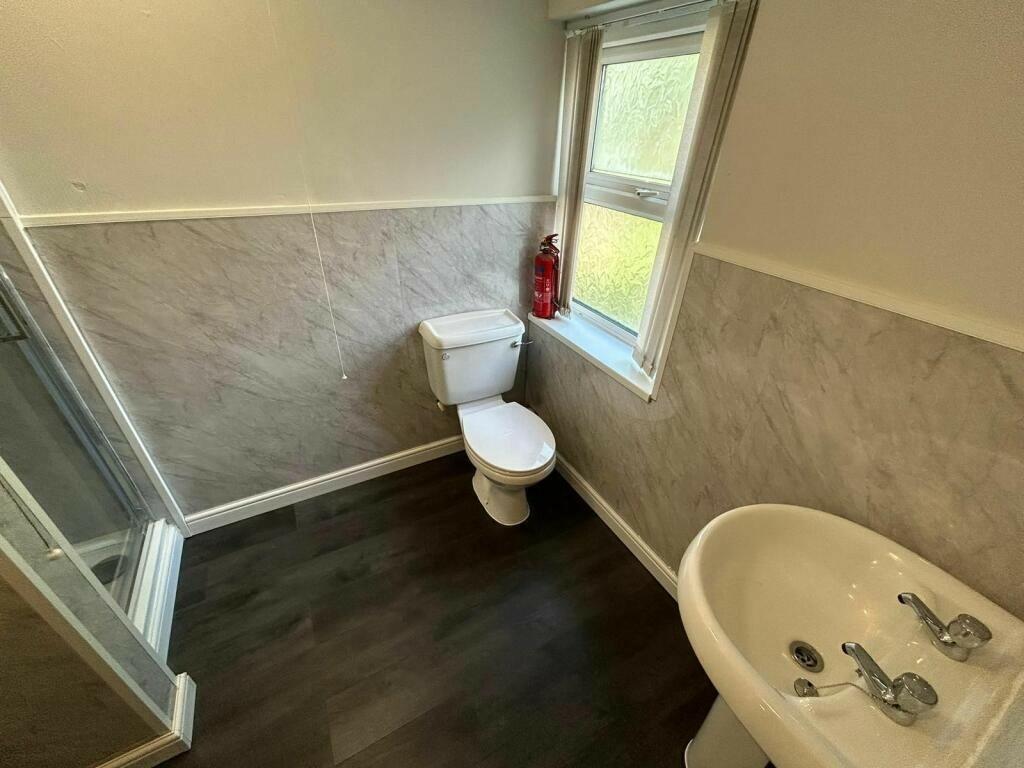 Bright bathroom featuring a modern white sink, ...
