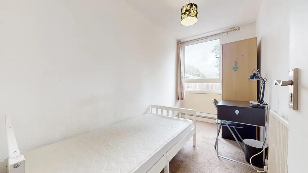 A bright and tidy single bedroom featuring a wh...