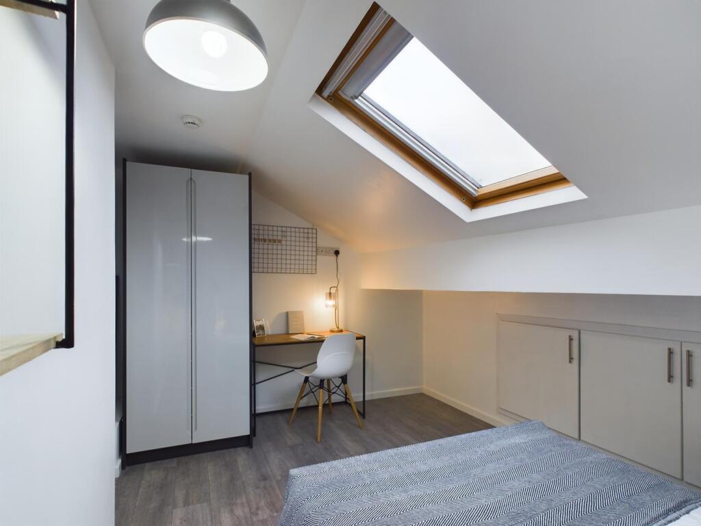 A bright and modern double bedroom featuring a ...
