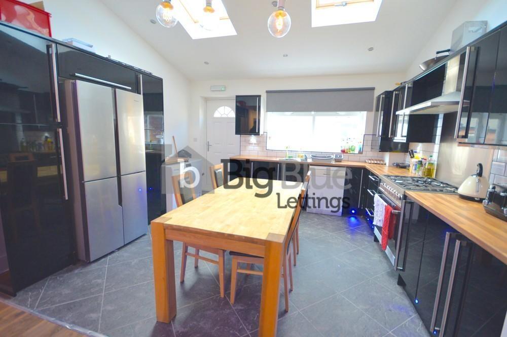 Bright and modern kitchen featuring ample natur...