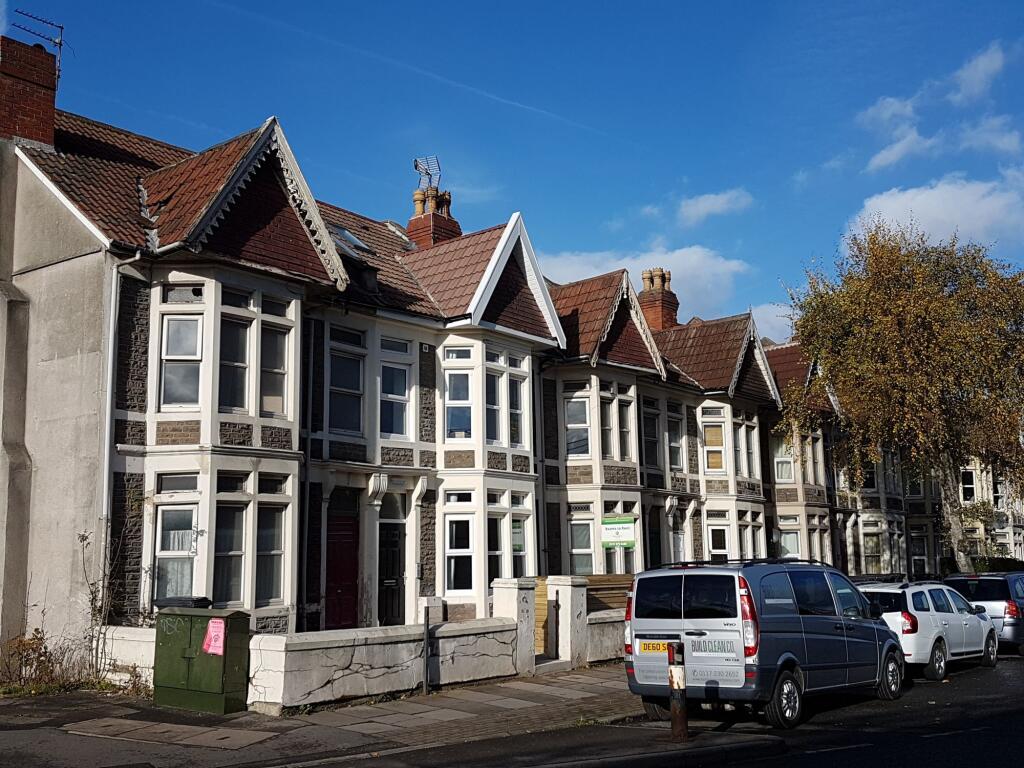A charming row of terraced houses under a brigh...