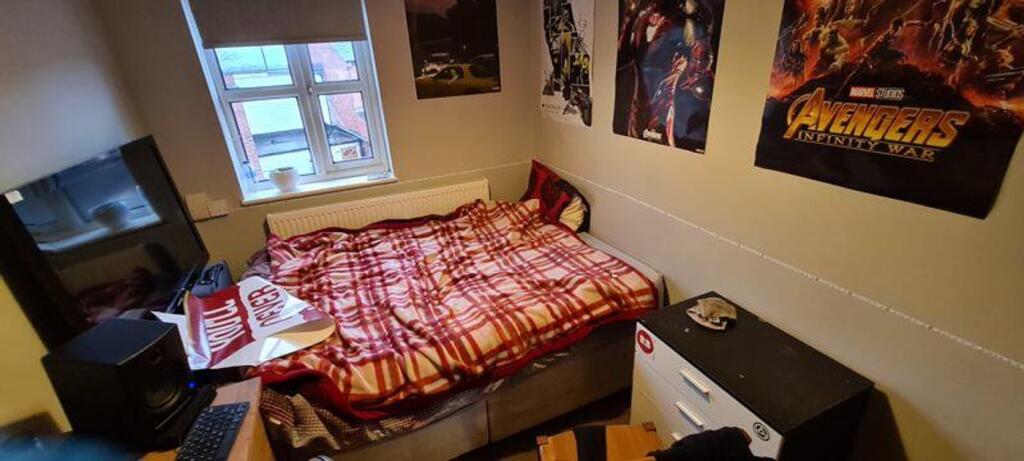 A cozy double bedroom featuring vibrant decor a...