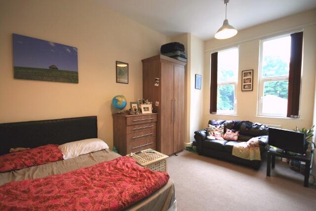 A well-lit and inviting living room with large ...