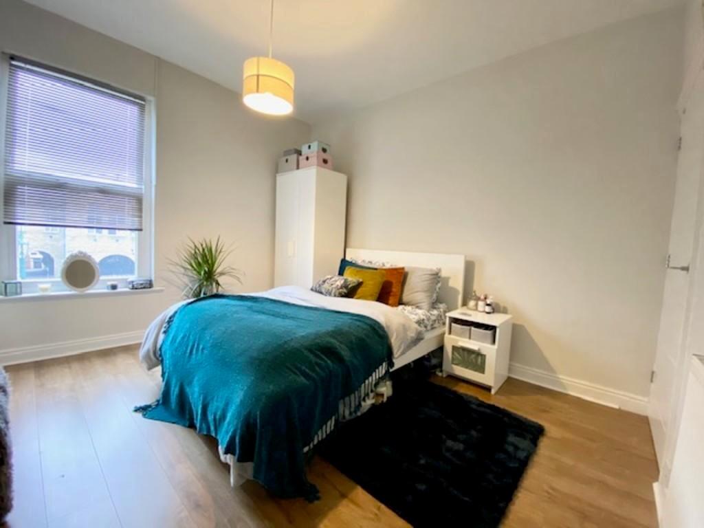 A bright and inviting double bedroom with a com...