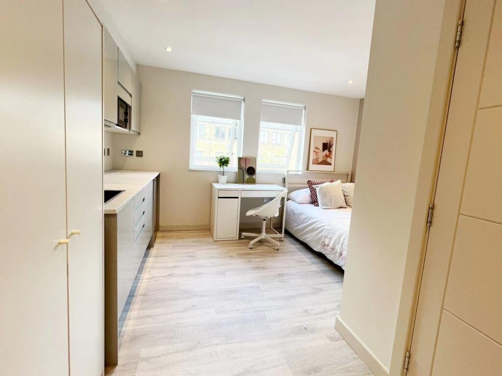 Bright and modern living room with large window...