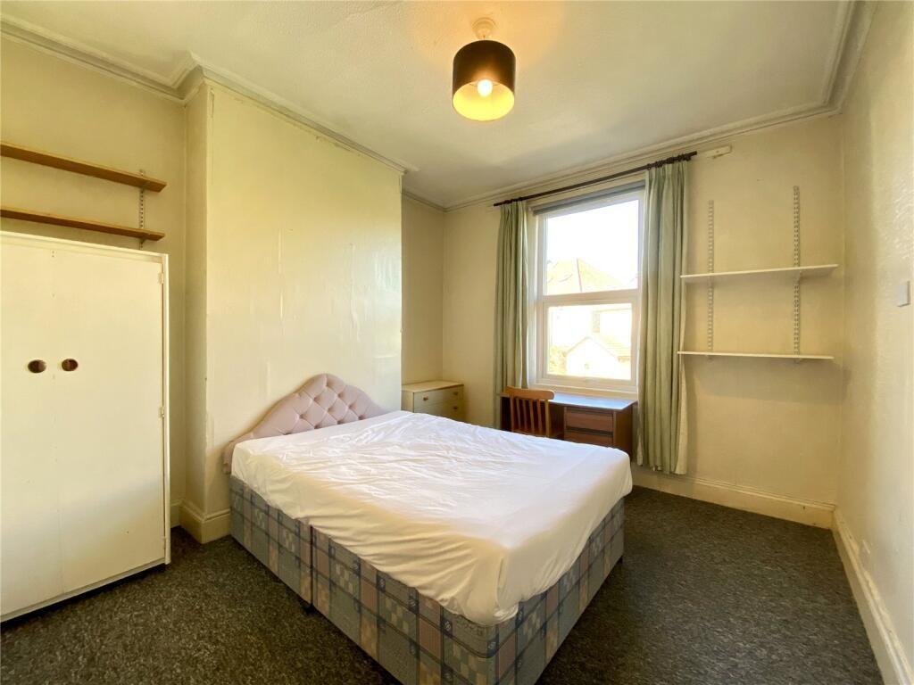 Bright double bedroom with a large window allow...