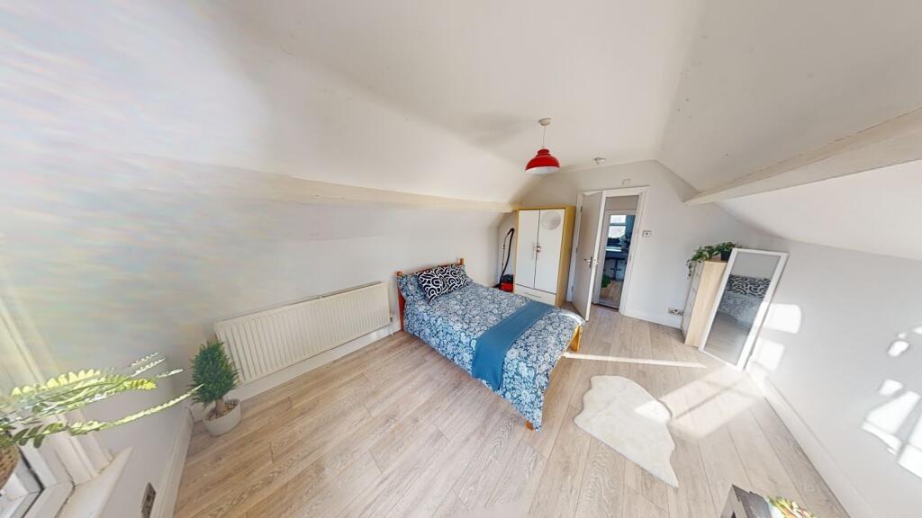 Bright and spacious master bedroom featuring a ...