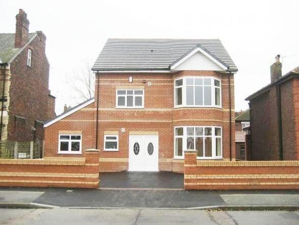 A well-maintained detached brick house with a n...