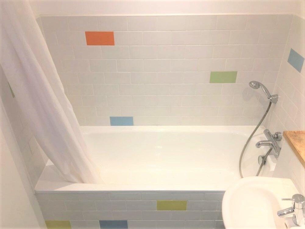 Bright and clean bathroom featuring a spacious ...