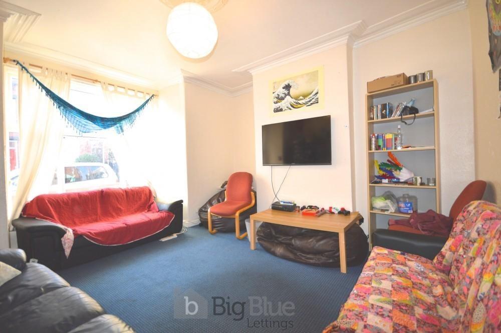 A cozy living room featuring a variety of comfo...