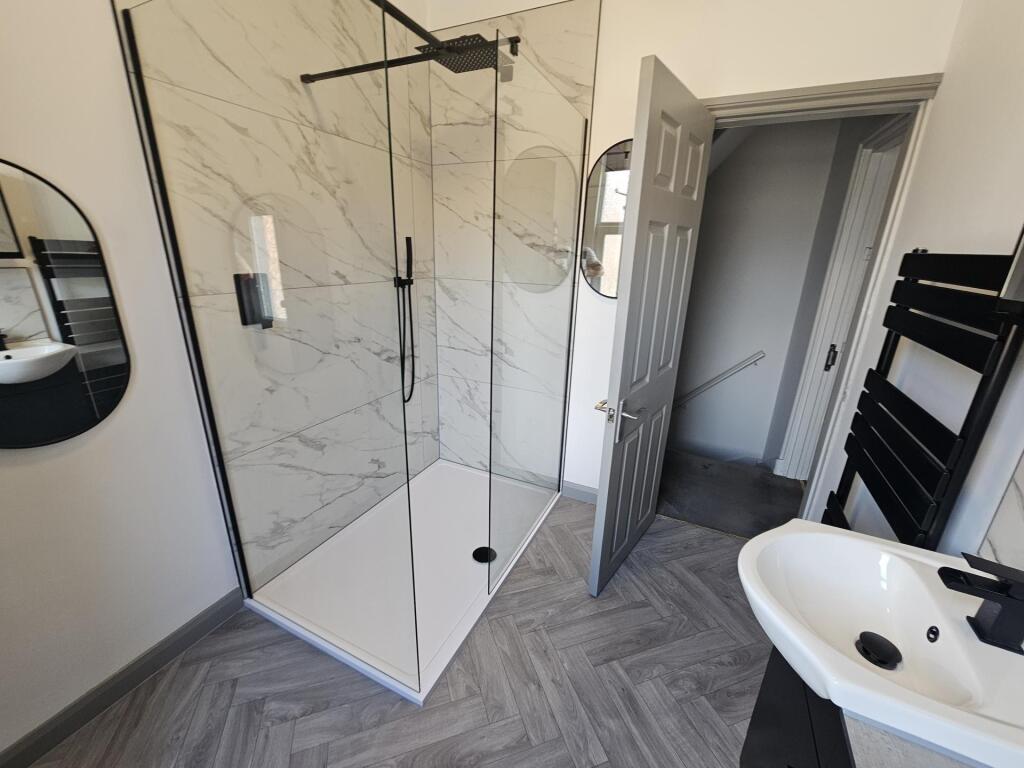 A modern, clean bathroom featuring a spacious s...