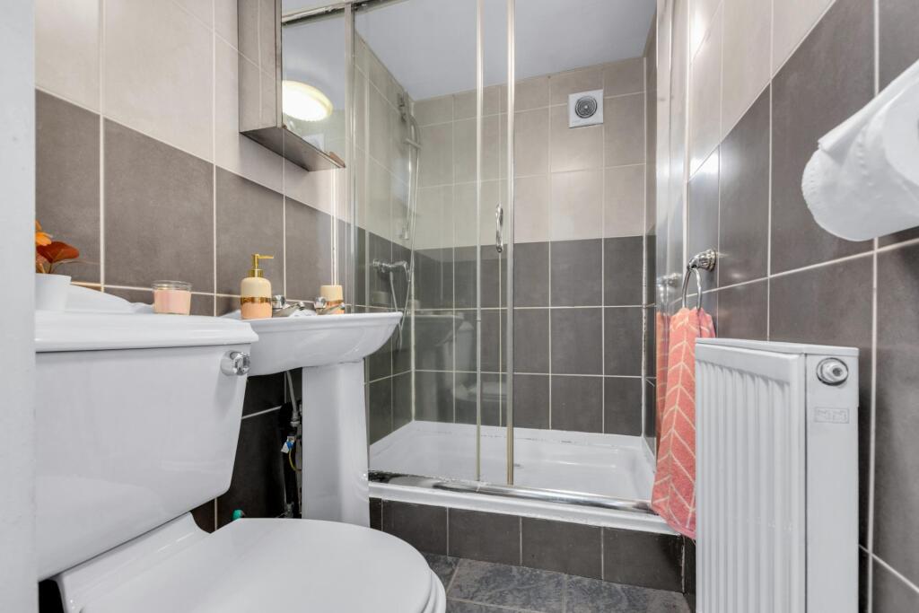 Modern bathroom featuring a clean white toilet ...
