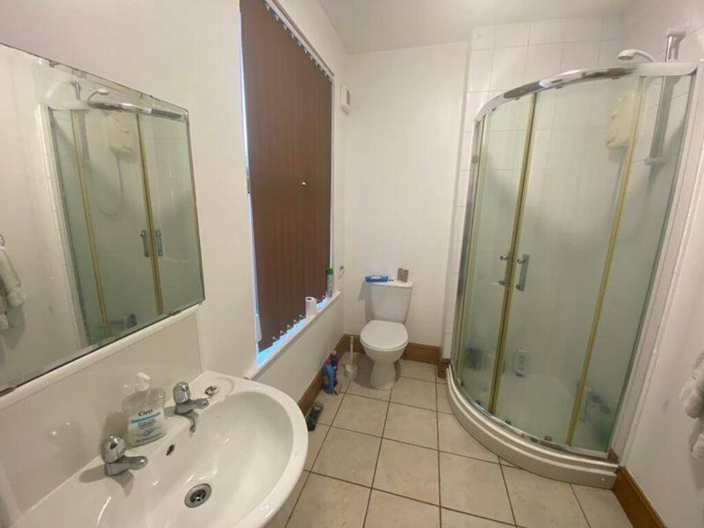 A clean and modern bathroom featuring a spaciou...