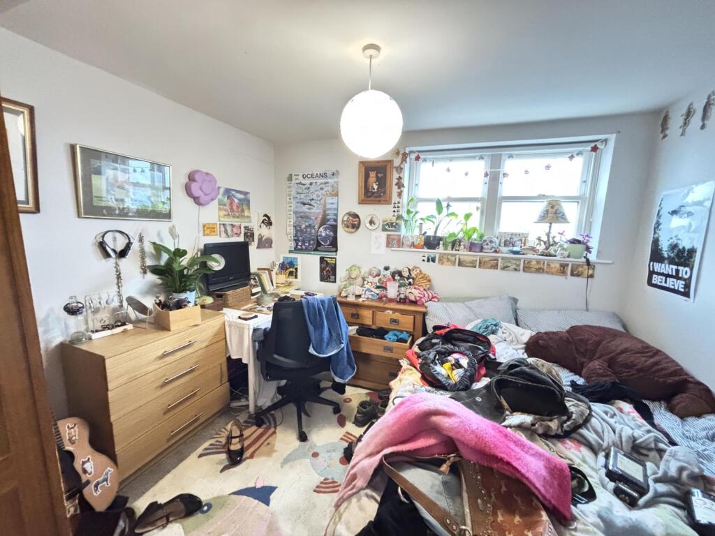 A lived-in living room with natural light comin...