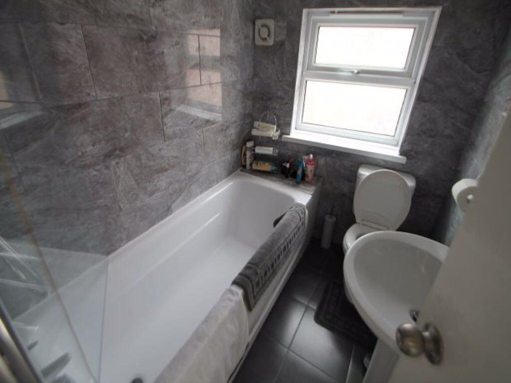 A clean and well-maintained bathroom featuring ...